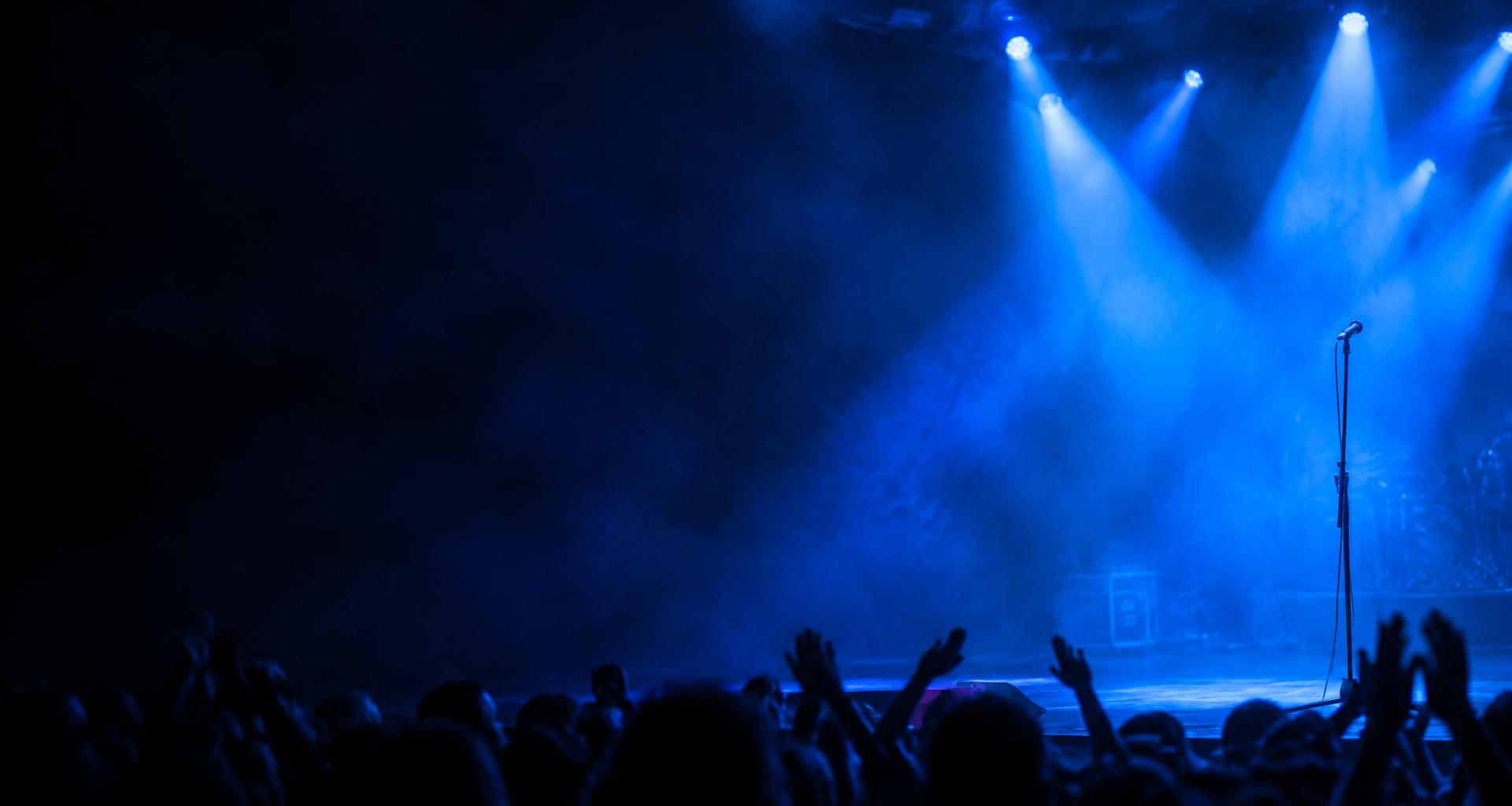 Atmospheric blue-lit stage artwork